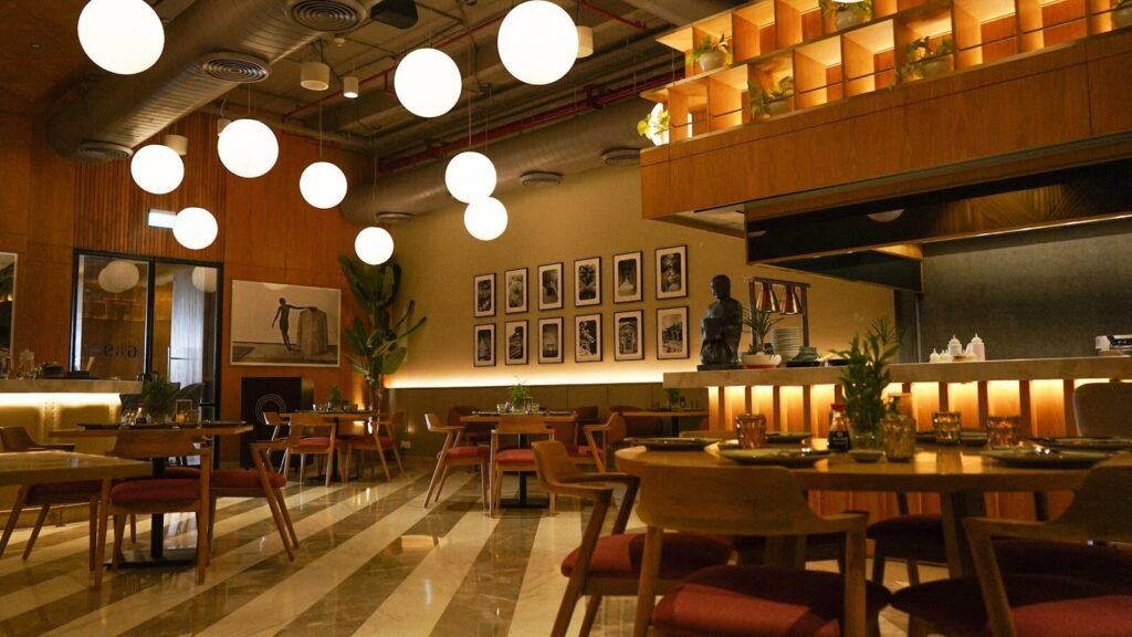 Sophisticated modern restaurant interior featuring warm ambient lighting and stylish furniture.